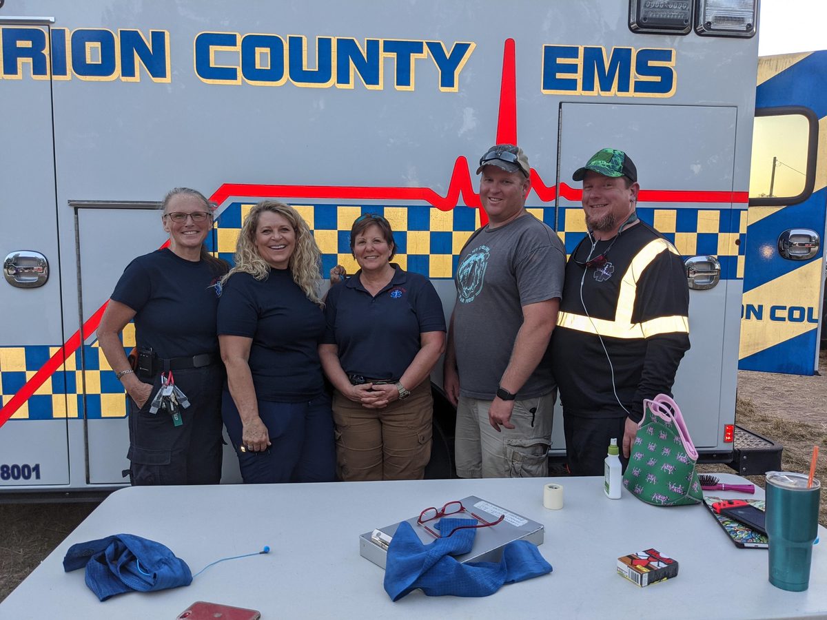 Irion County EMS crew members standing in front of their ambulance